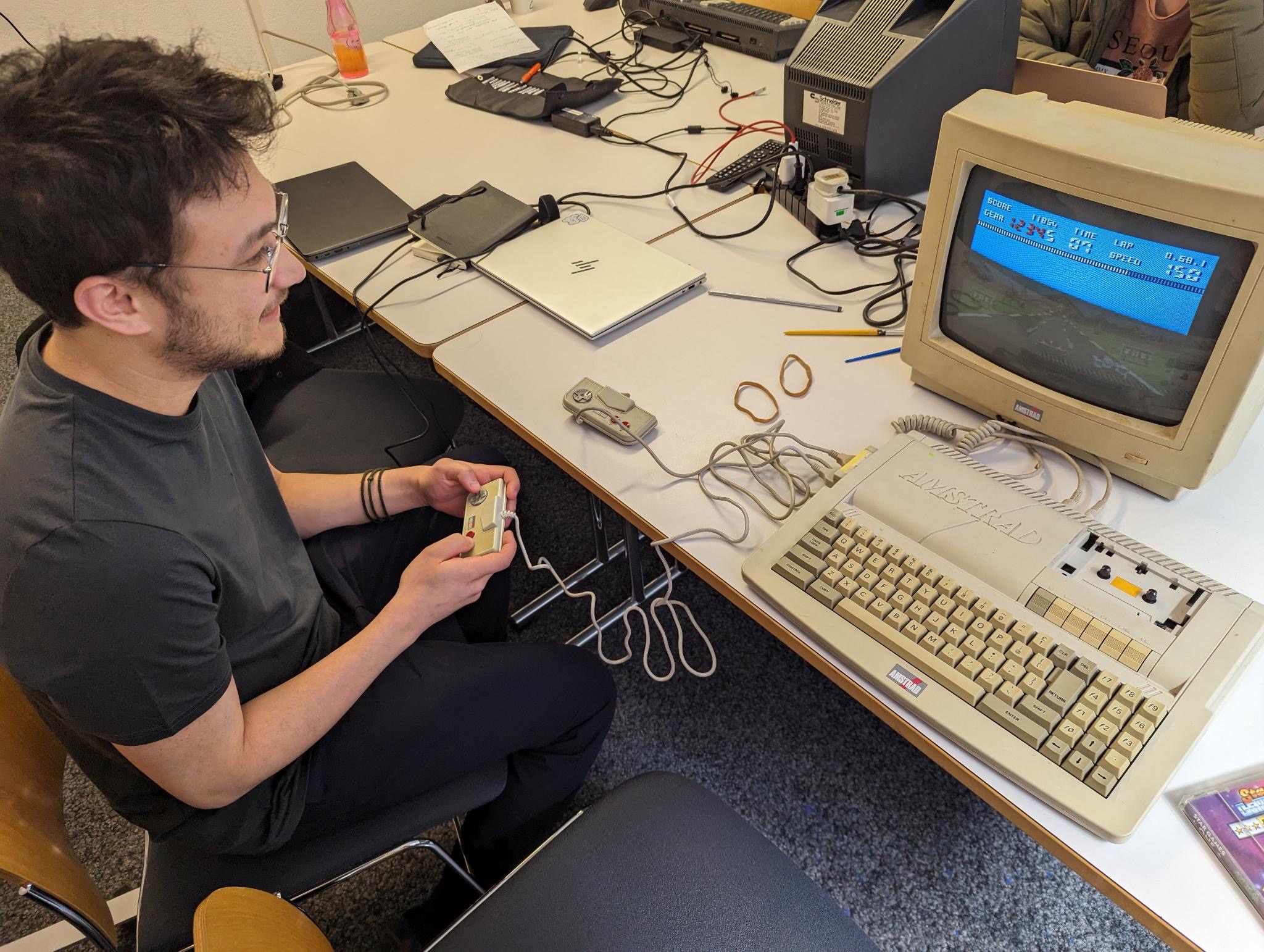 Picture of Anthony playing on a retro computer